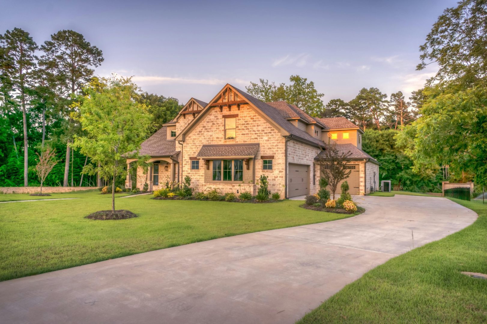 Beautiful residential home with freshly poured concrete driveway by Titans Concrete Inc.